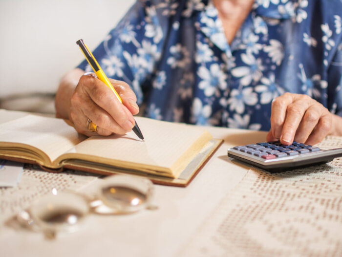 Close Up Of Unrecognizable Senior Woman Doing Finances At Home.